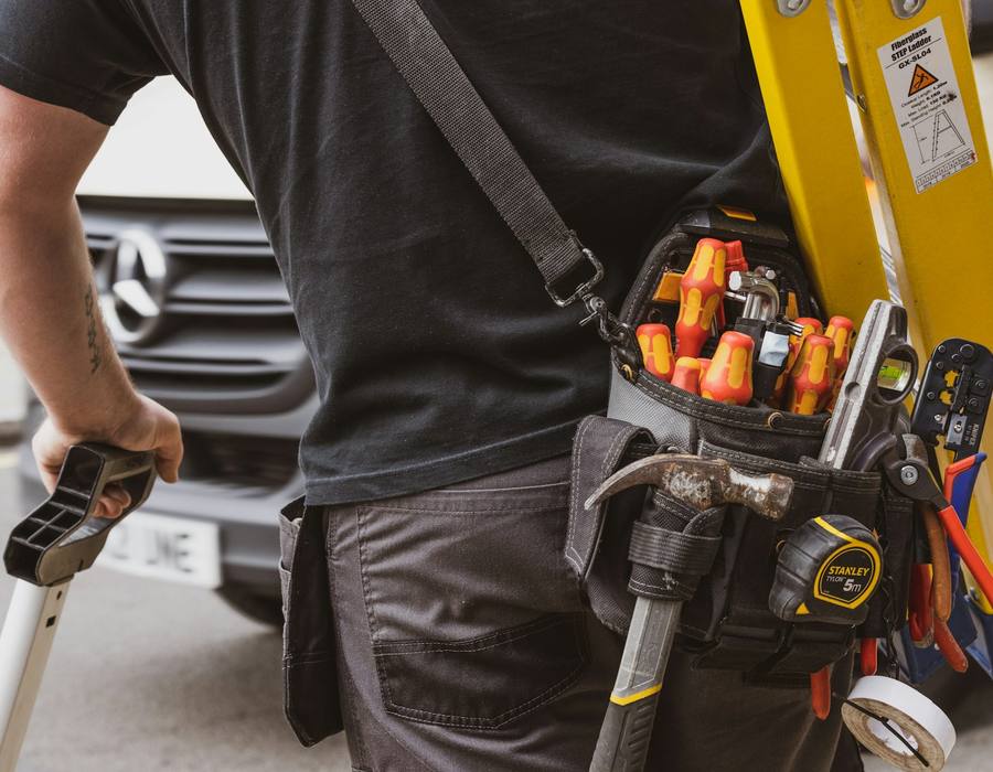 Technician's tool belt loaded with hand tools